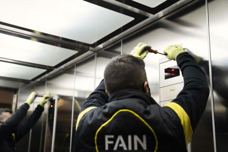 Técnico FAIN poniendo una botonera ascensor FAIN